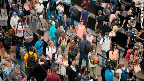 Travelers queue up at the south security checkpoint in Denver International Airport as the Labor Day holiday approaches,on Tuesday, August. 30, 2022.